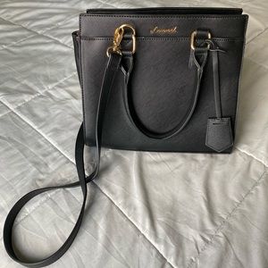 black purse with top handle and crossbody strap